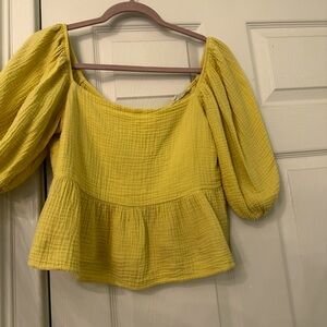 Yellow blouse with puffy sleeves.
